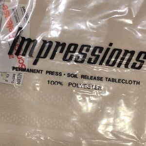 NEW 60”X104” oval tablecloth, 100% polyester NWTs light Beige. Great gift!